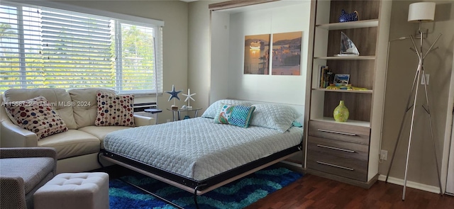 bedroom with dark wood-type flooring