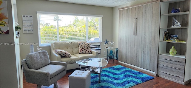 sitting room featuring a wealth of natural light and dark wood-type flooring