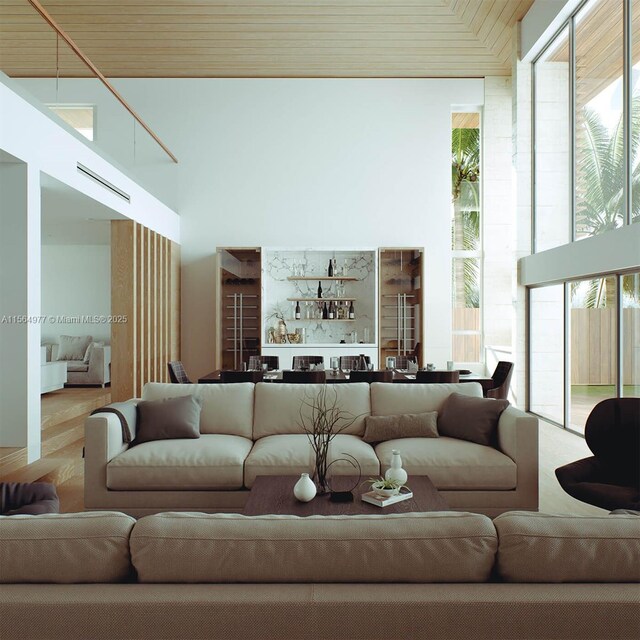 living room featuring bar, hardwood / wood-style floors, and wood ceiling