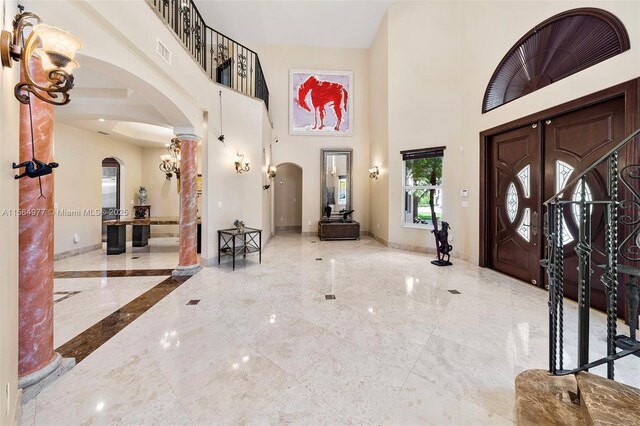 entrance foyer featuring a towering ceiling