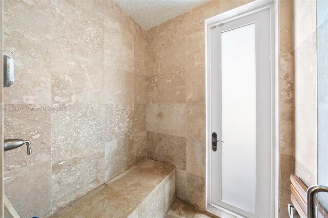 bathroom with tiled shower