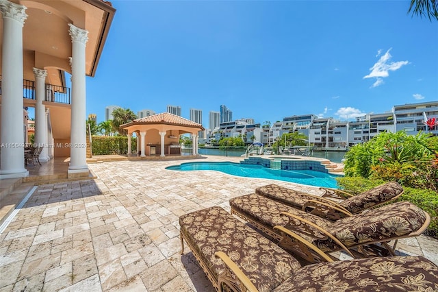 view of swimming pool featuring a gazebo, a patio area, and an in ground hot tub