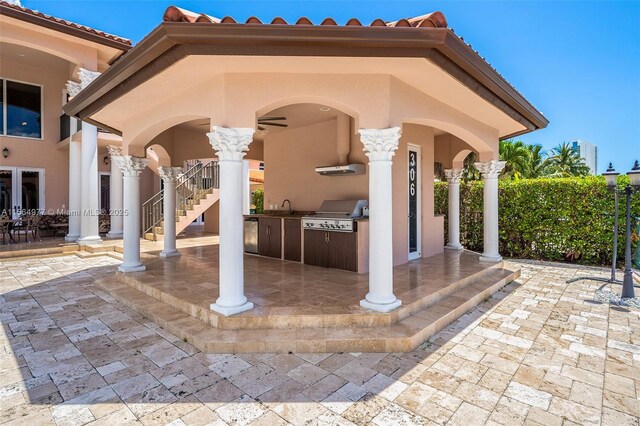 view of patio with area for grilling, sink, and an outdoor kitchen