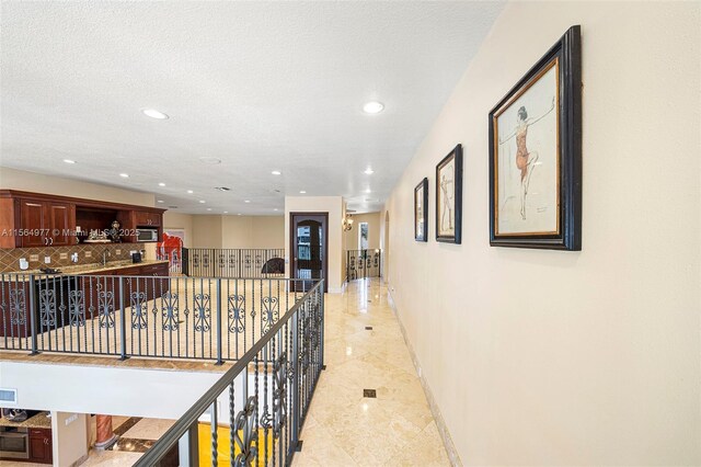 hallway with a textured ceiling