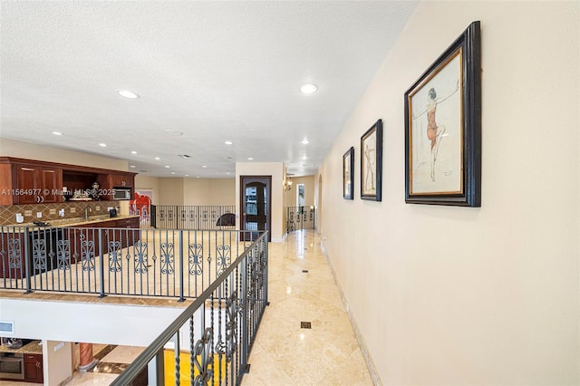 corridor featuring a textured ceiling