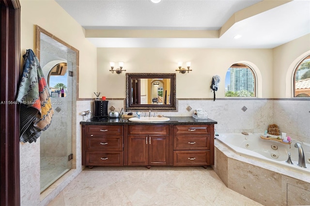 bathroom featuring tile patterned flooring, shower with separate bathtub, and vanity