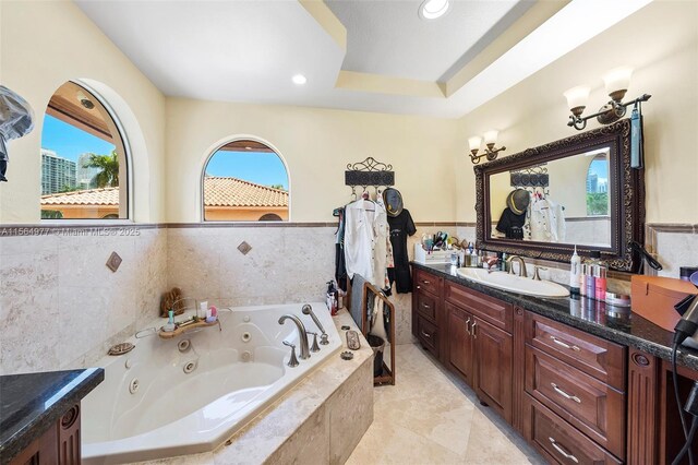 bathroom with vanity and a relaxing tiled tub