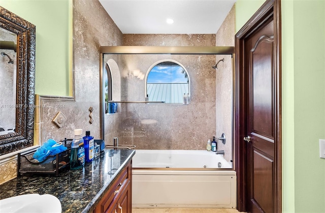 bathroom featuring vanity and a bath