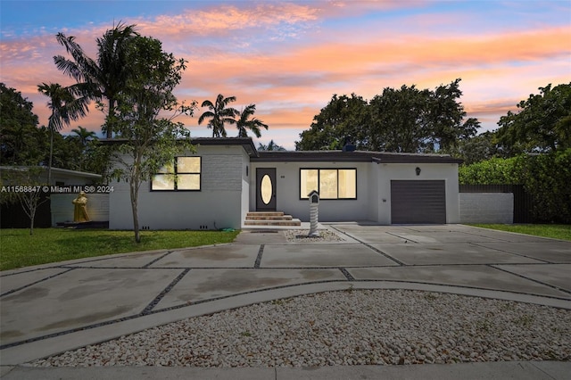 view of front facade with a garage and a yard