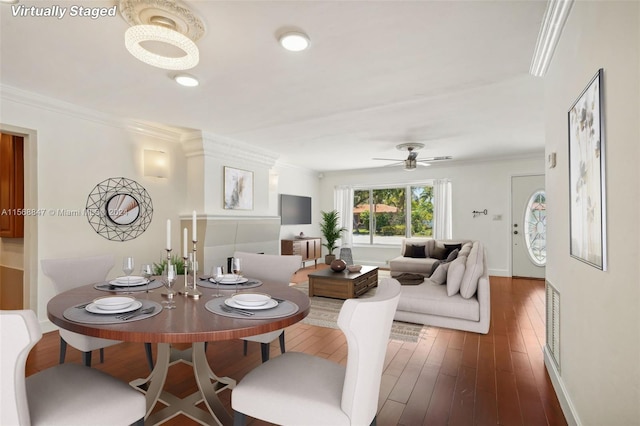 dining room featuring ceiling fan, dark wood-type flooring, and ornamental molding