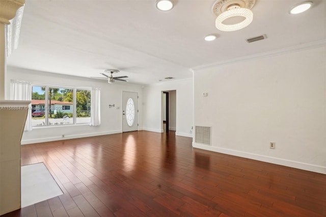 unfurnished living room featuring ceiling fan, dark hardwood / wood-style flooring, and ornamental molding