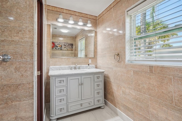 bathroom featuring plenty of natural light, tile walls, and vanity