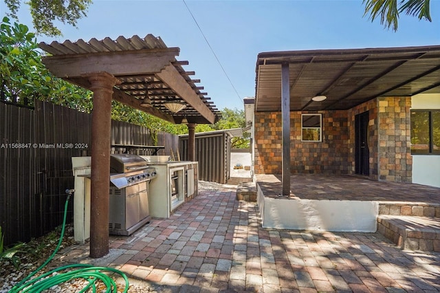 view of patio with an outdoor kitchen and a pergola