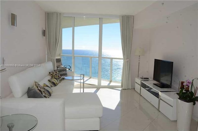 living room with light tile floors and a water view