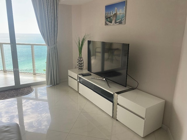 bedroom with light tile flooring and a water view