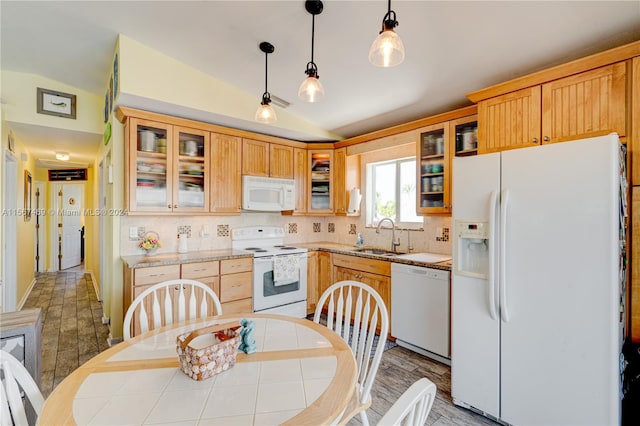 kitchen with sink, white appliances, decorative light fixtures, backsplash, and vaulted ceiling