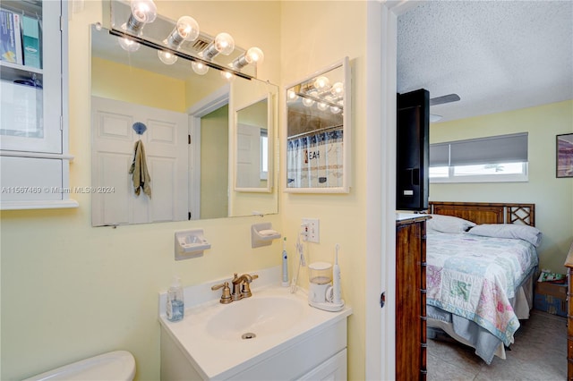 bathroom with vanity, a textured ceiling, tile patterned flooring, a shower with shower curtain, and toilet