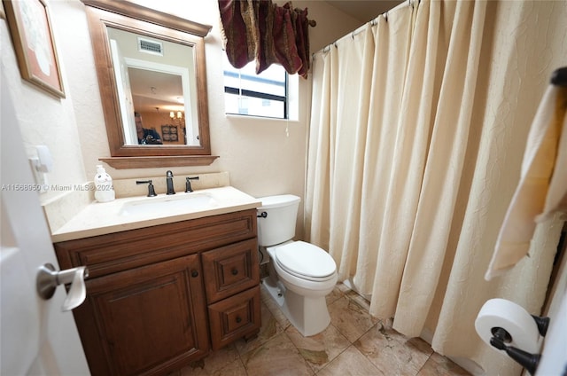 bathroom featuring vanity, toilet, and tile flooring