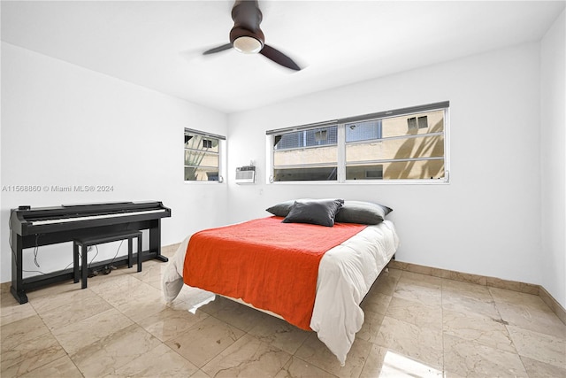 bedroom featuring a wall unit AC and ceiling fan