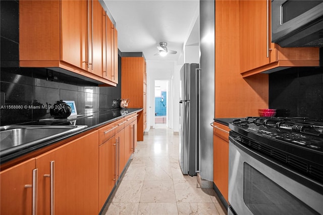 kitchen with appliances with stainless steel finishes, backsplash, and sink