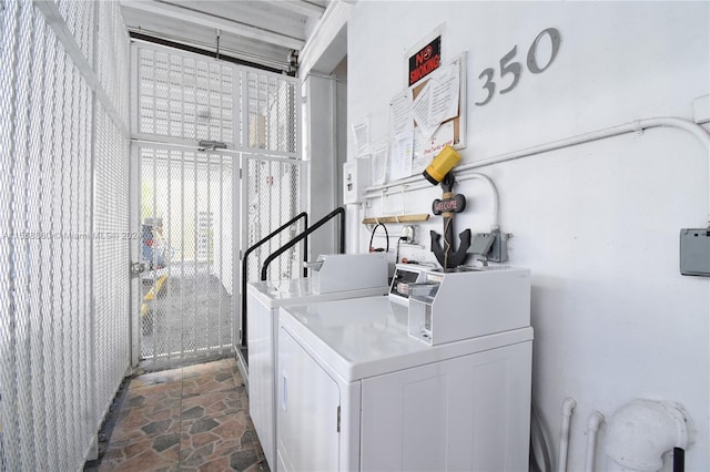 clothes washing area featuring independent washer and dryer