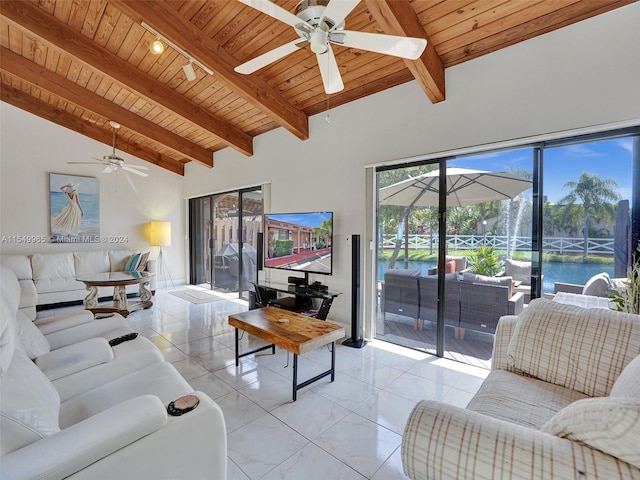 tiled living room with wooden ceiling, a water view, ceiling fan, and vaulted ceiling with beams