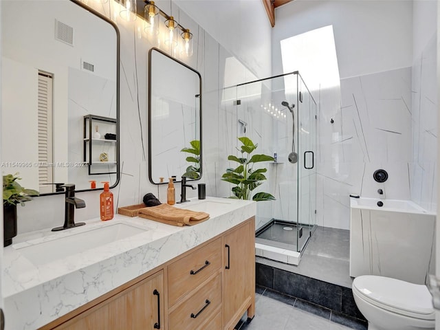 bathroom featuring walk in shower, toilet, tile flooring, and double sink vanity