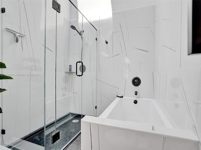 bathroom featuring separate shower and tub