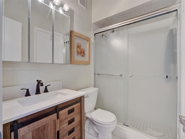 bathroom featuring walk in shower, vanity, and toilet