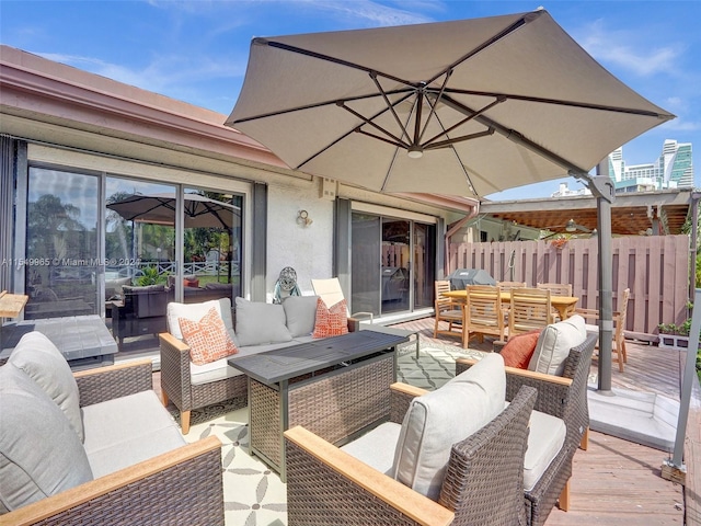 view of terrace with a deck, a grill, and an outdoor hangout area