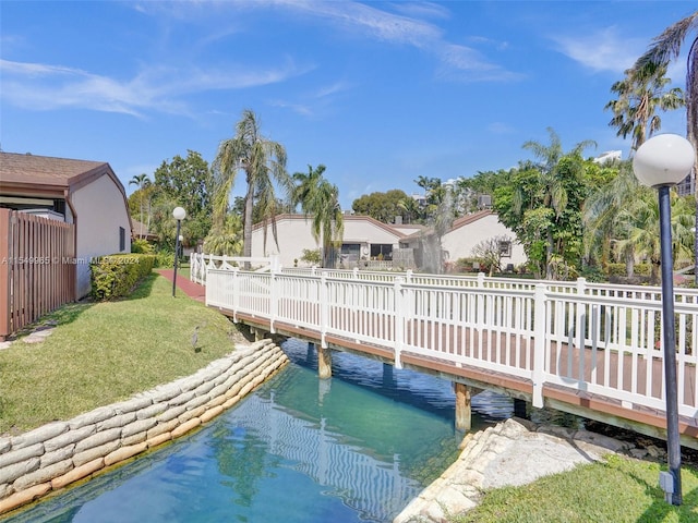 view of dock featuring a lawn