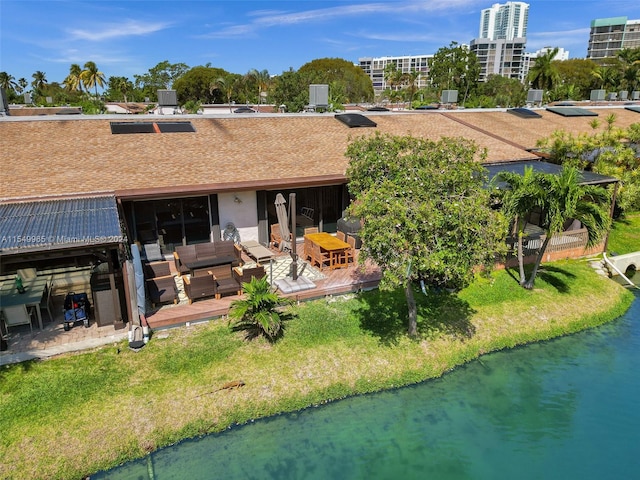 rear view of house featuring a deck and outdoor lounge area