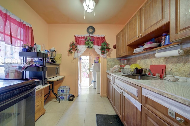 kitchen with backsplash and light tile flooring