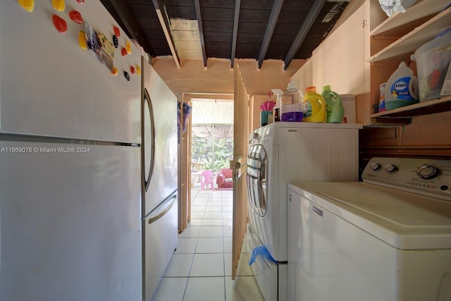 laundry room featuring independent washer and dryer, light tile floors, and wood ceiling