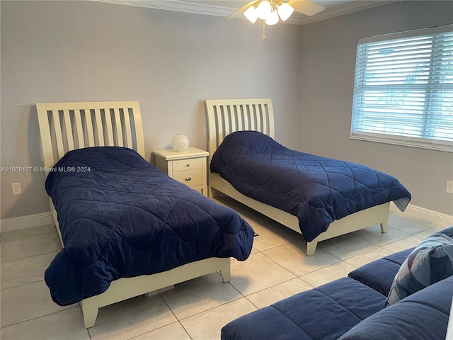 bedroom with ceiling fan, crown molding, and light tile floors