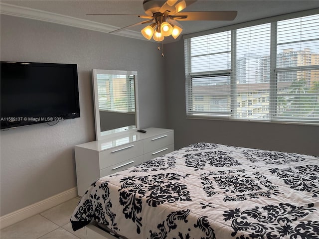 tiled bedroom featuring ornamental molding and ceiling fan