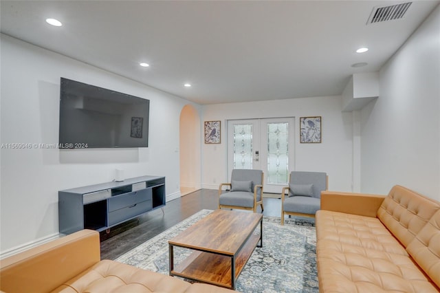 living room featuring dark hardwood / wood-style flooring and french doors