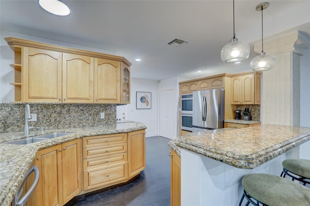 kitchen with stainless steel appliances, light brown cabinetry, tasteful backsplash, and sink