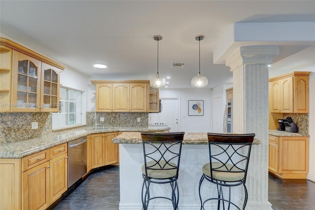 kitchen featuring dark wood-type flooring, a breakfast bar area, tasteful backsplash, and stainless steel dishwasher