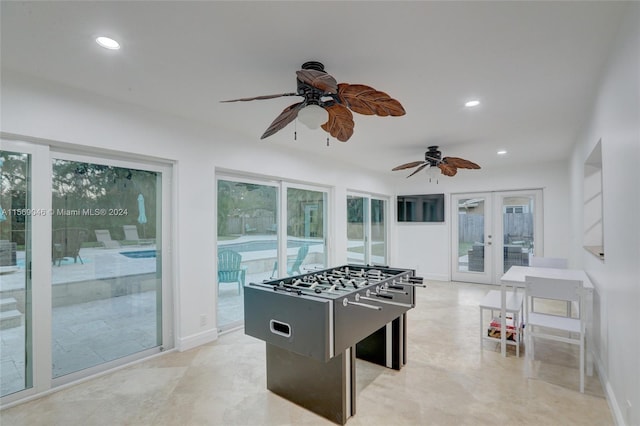 recreation room featuring plenty of natural light, french doors, ceiling fan, and light tile patterned floors