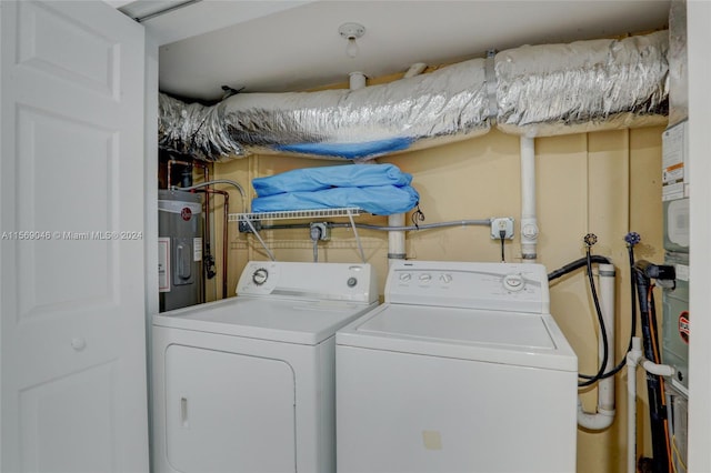 washroom featuring electric water heater and washing machine and clothes dryer