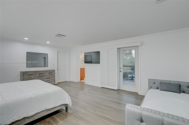 bedroom with hardwood / wood-style flooring, access to outside, and ornamental molding