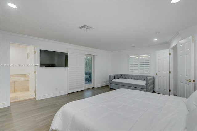 bedroom with access to exterior, connected bathroom, crown molding, and hardwood / wood-style floors