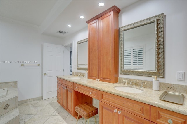 bathroom featuring dual vanity, tile patterned flooring, and a washtub