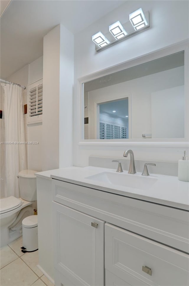 bathroom with tile patterned floors, vanity, and toilet