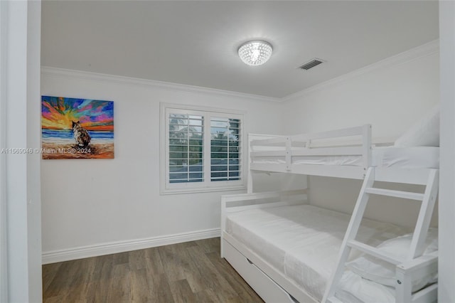 bedroom featuring hardwood / wood-style flooring and crown molding