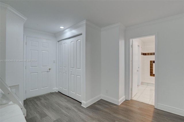 corridor featuring hardwood / wood-style flooring and ornamental molding