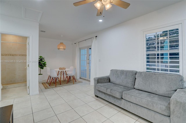 tiled living room with ceiling fan