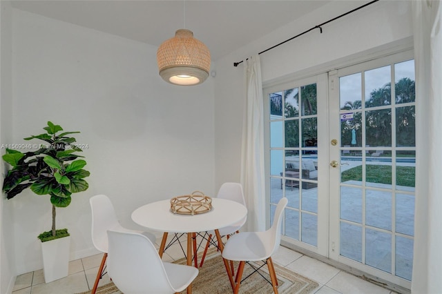 tiled dining room featuring french doors