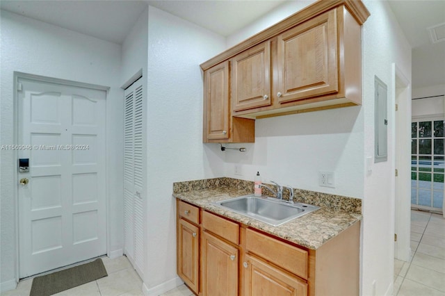 kitchen with electric panel, sink, and light tile patterned floors